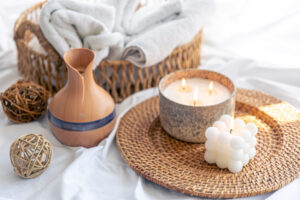 Cozy spa setup with candles, diffuser, and towels in Auburn, AL. Relaxation and tranquility atmosphere.