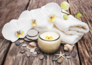 Spa essentials with candle and orchids in Auburn, AL for relaxation and tranquility.