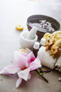 Spa essentials with flowers and oils for a wellness retreat in Auburn, AL.