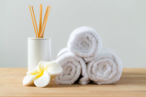 Spa essentials with towels and aroma sticks, Auburn, AL. Perfect for relaxation and wellness retreats.