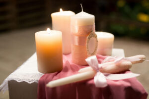 Elegant candles on a pink cloth, spa near Bent Creek Auburn, AL. Perfect for weddings or events. Warm, inviting ambiance.